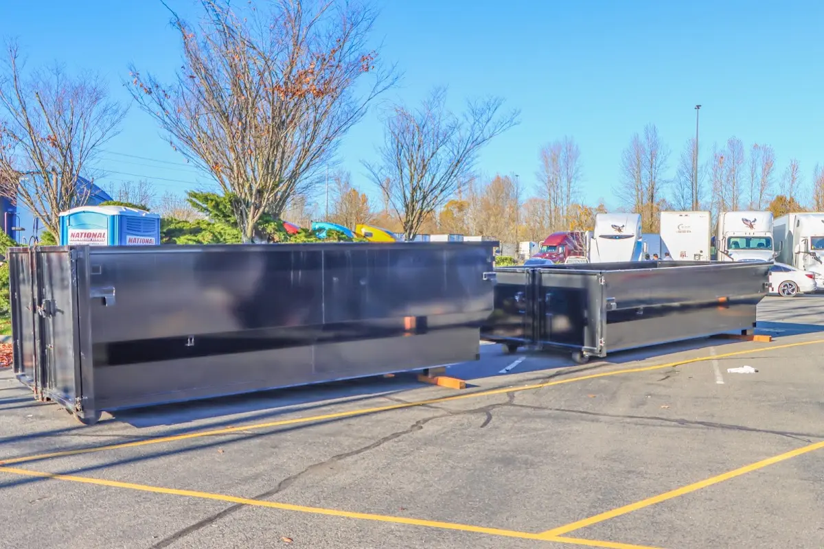 Professional dumpster rental service with roll-off container on residential driveway in Newnan